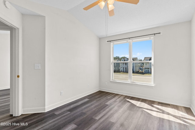 unfurnished room featuring baseboards, visible vents, lofted ceiling, ceiling fan, and dark wood-type flooring