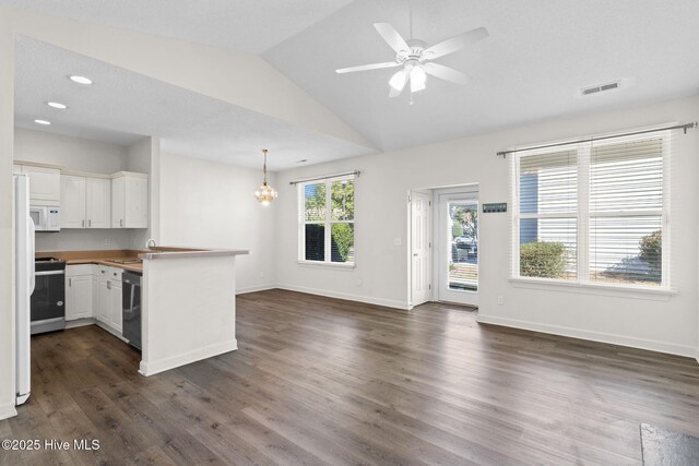 interior space featuring range with gas stovetop, dishwasher, white microwave, a peninsula, and visible vents