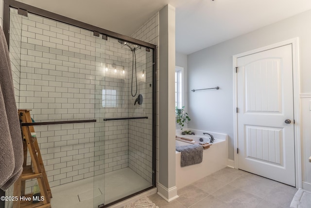 bathroom featuring independent shower and bath and tile patterned flooring