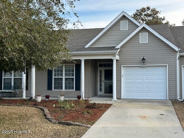 single story home with a porch, concrete driveway, roof with shingles, and an attached garage