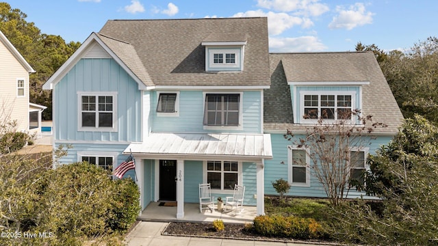 view of front of house featuring board and batten siding, roof with shingles, and a porch