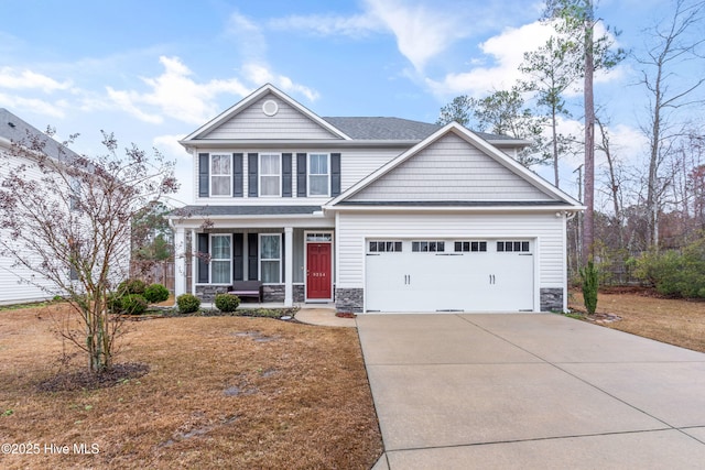 view of front of property with a garage, concrete driveway, stone siding, and covered porch