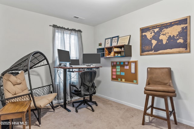 office featuring light carpet, baseboards, and visible vents