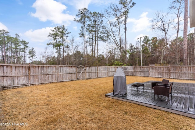 view of yard with a fenced backyard and a wooden deck