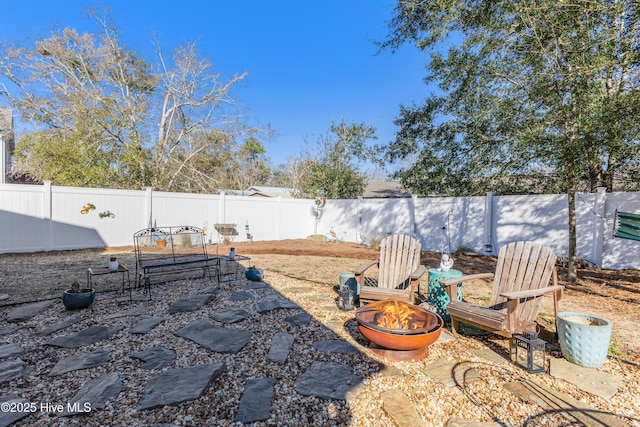 view of yard with a patio area, an outdoor fire pit, and a fenced backyard