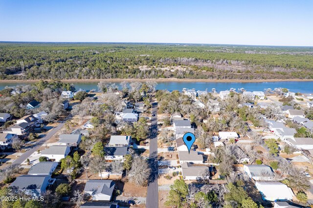 aerial view featuring a water view, a residential view, and a view of trees