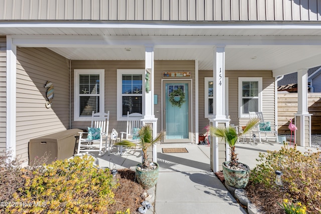 view of exterior entry featuring covered porch