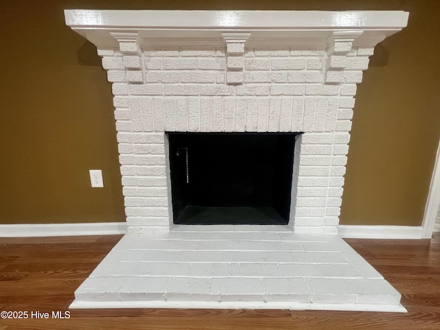 1206 N Bonner St, Washington, NC 27889 - unfurnished living room with crown molding, recessed lighting, baseboards, a brick fireplace, and wood finished floors