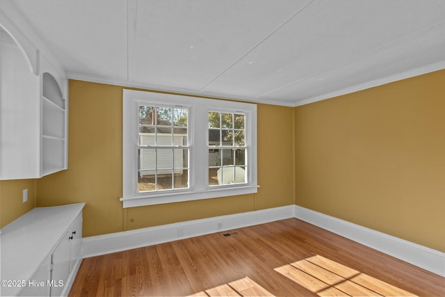 1206 N Bonner St, Washington, NC 27889 - unfurnished dining area with baseboards, visible vents, ornamental molding, and wood finished floors