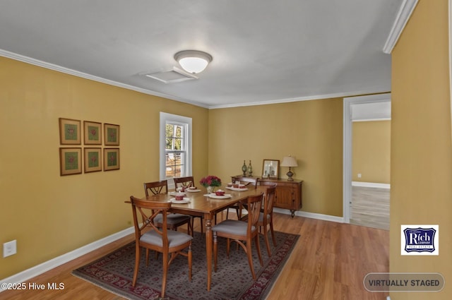 1206 N Bonner St, Washington, NC 27889 - dining room featuring baseboards, light wood-style floors, and crown molding