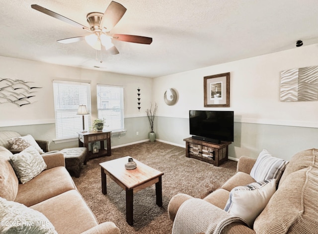 living area with a textured ceiling, ceiling fan, carpet, and baseboards