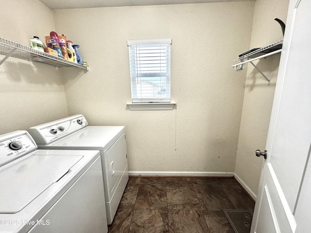 laundry room with laundry area, baseboards, and separate washer and dryer