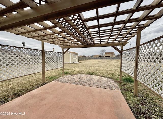 view of patio / terrace with an outbuilding, a storage unit, a fenced backyard, and a pergola