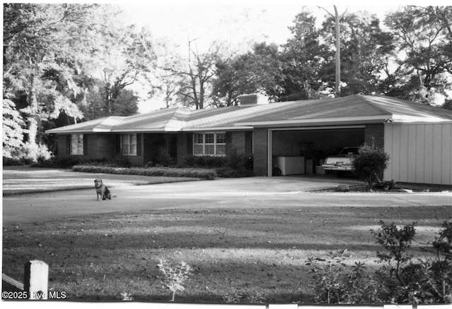 view of front of property with an attached garage and brick siding