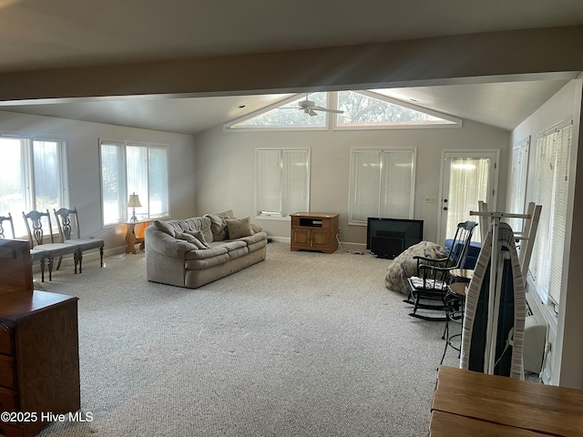 carpeted living area featuring lofted ceiling with beams, ceiling fan, and baseboards