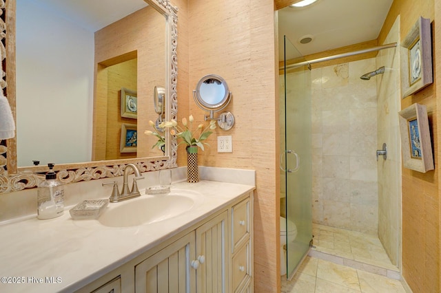 full bath with a stall shower and vanity