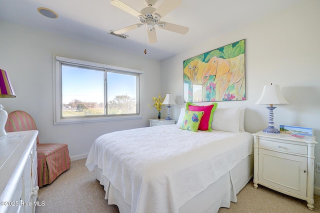bedroom with light carpet, ceiling fan, visible vents, and baseboards