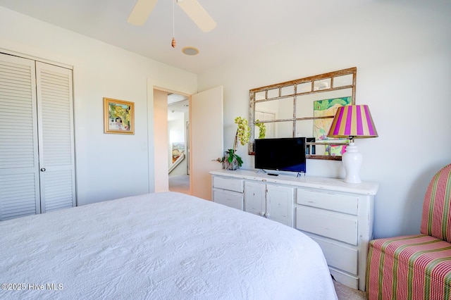bedroom with ceiling fan and a closet