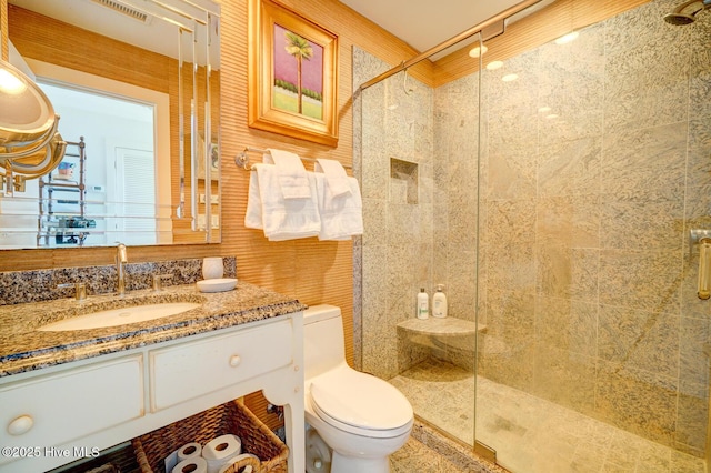 full bath with a shower stall, toilet, and vanity