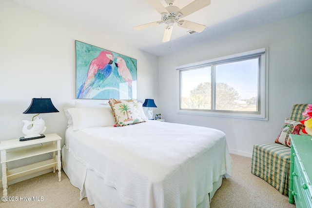 bedroom featuring visible vents, baseboards, ceiling fan, and light colored carpet