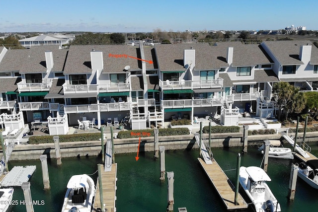 view of dock featuring a water view and a residential view