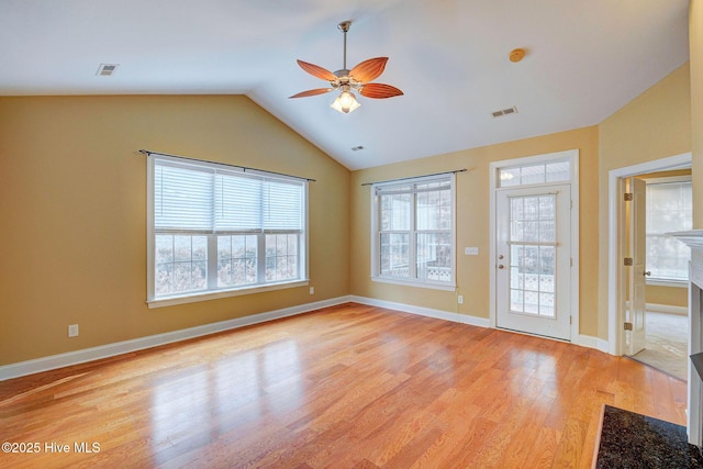 interior space featuring lofted ceiling, visible vents, ceiling fan, and light wood-style flooring