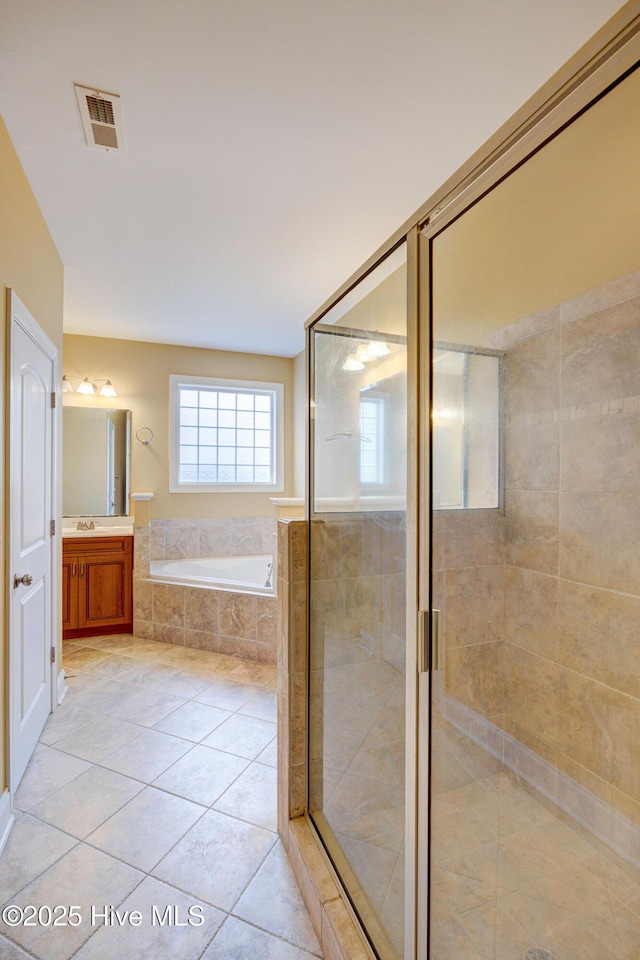 full bath featuring a garden tub, visible vents, a stall shower, vanity, and tile patterned floors