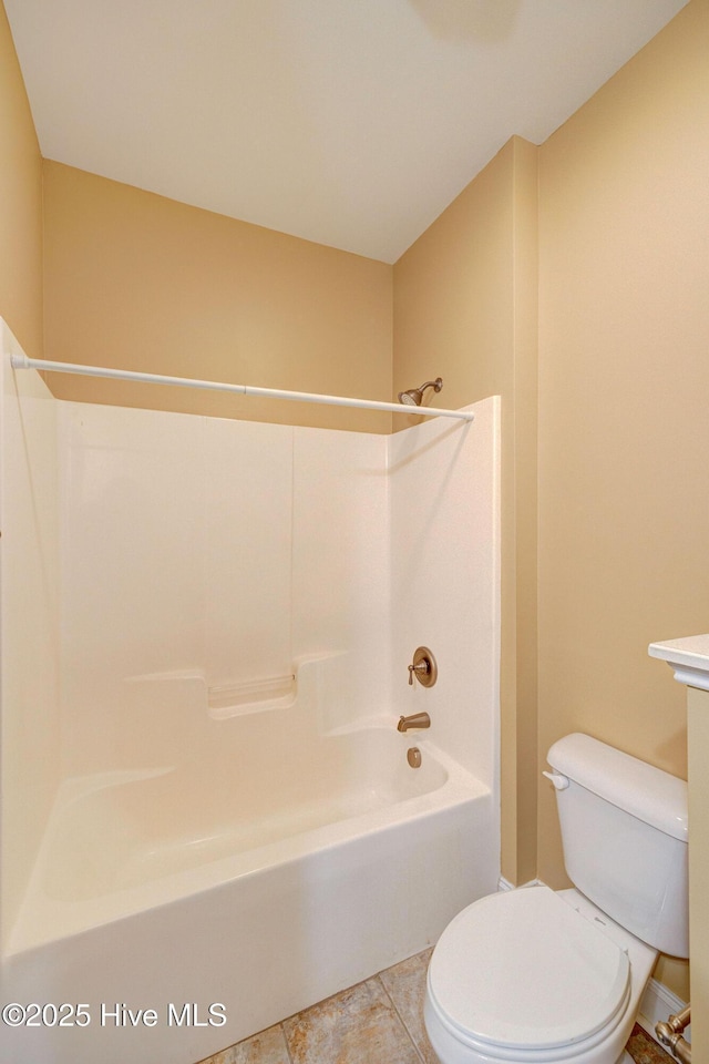 bathroom featuring toilet, vanity,  shower combination, and tile patterned floors