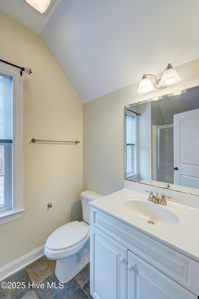 full bathroom featuring lofted ceiling, a stall shower, plenty of natural light, and vanity