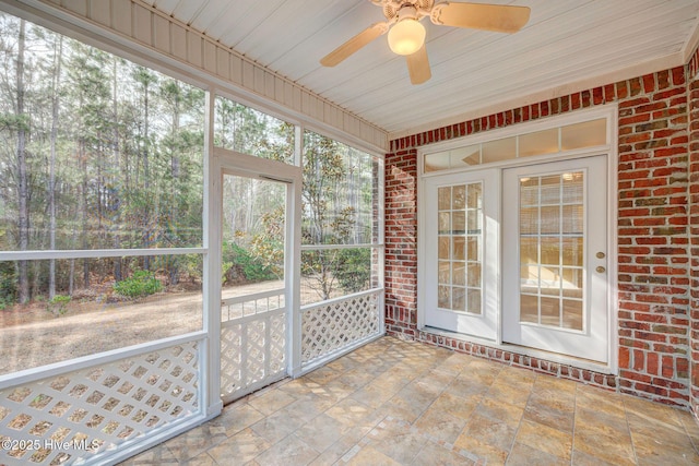 unfurnished sunroom featuring a wealth of natural light and a ceiling fan