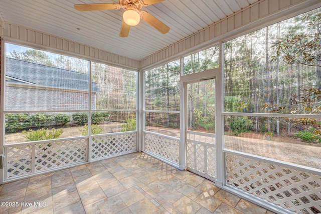 unfurnished sunroom with a ceiling fan