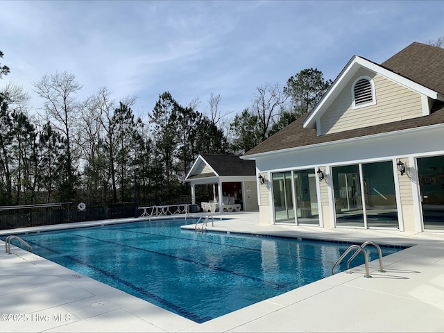 pool with fence and a patio