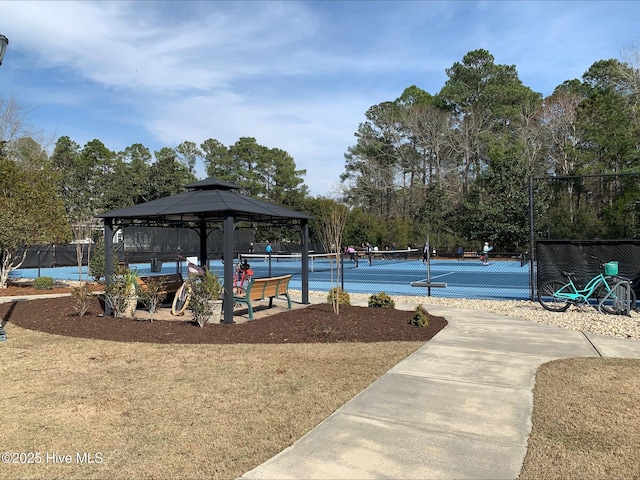 surrounding community featuring a tennis court, a gazebo, and fence