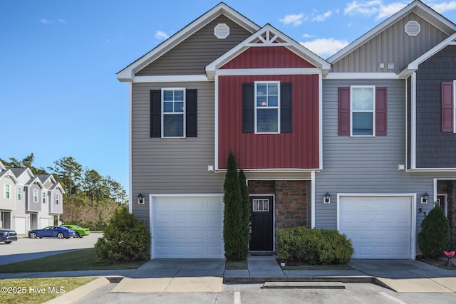 view of front of home featuring a garage, board and batten siding, and stone siding