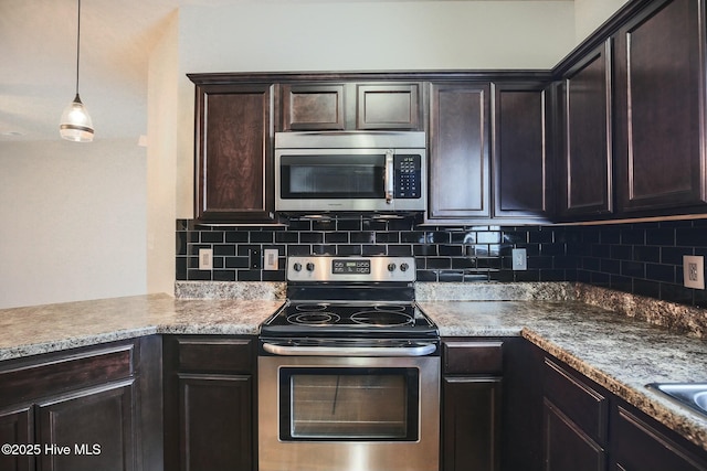 kitchen with hanging light fixtures, dark brown cabinetry, appliances with stainless steel finishes, and backsplash