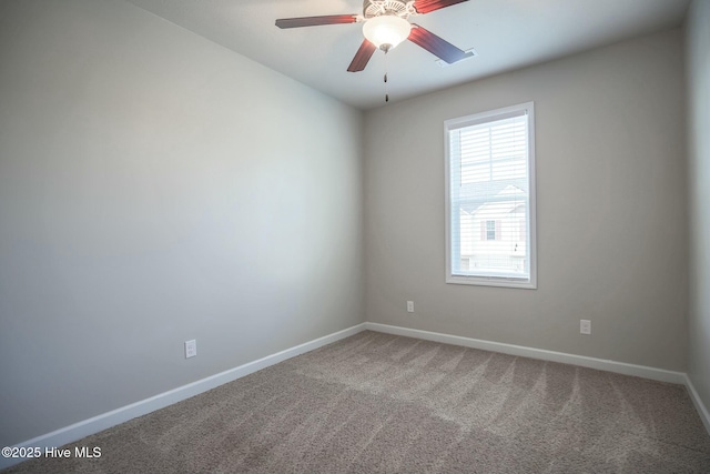 carpeted empty room with baseboards, visible vents, and ceiling fan