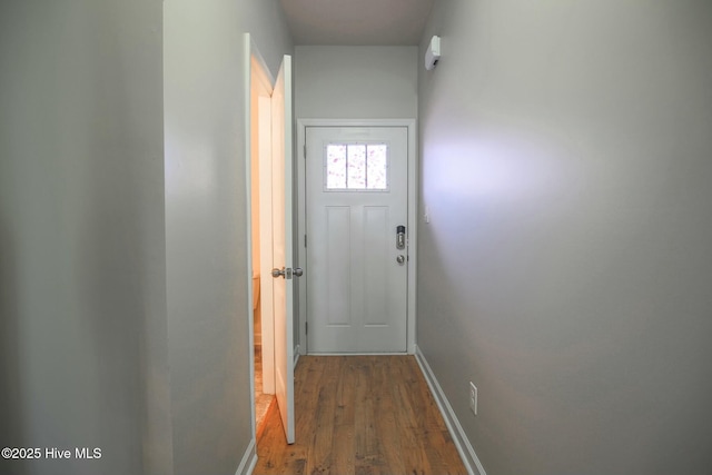 entryway featuring dark wood-style flooring and baseboards