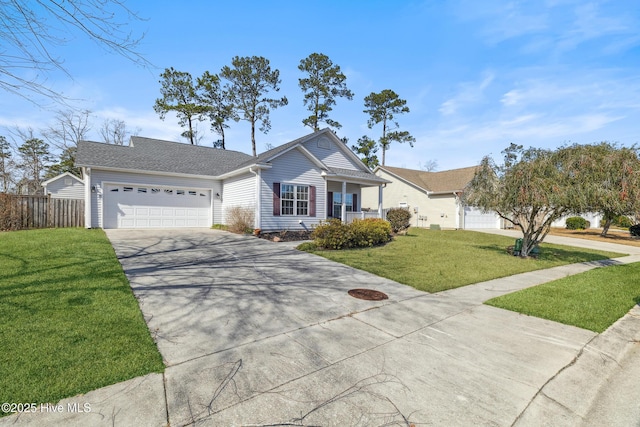 view of front of house featuring an attached garage, driveway, a front yard, and fence