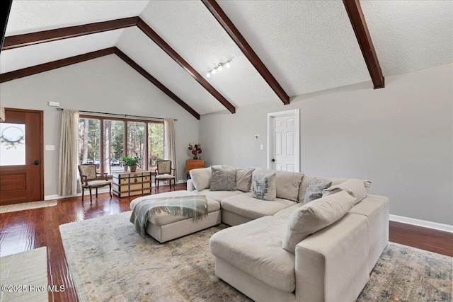 living area with baseboards, dark wood finished floors, a textured ceiling, high vaulted ceiling, and beam ceiling