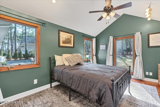 bedroom featuring vaulted ceiling, wood finished floors, a ceiling fan, and baseboards