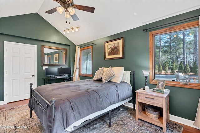 bedroom featuring dark wood-style flooring, vaulted ceiling, and baseboards