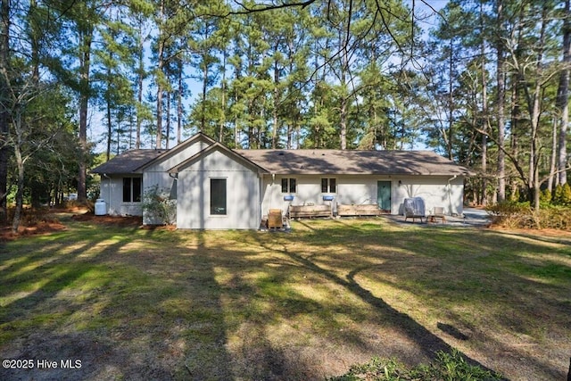 back of house featuring a yard