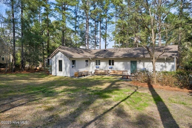 rear view of property with a yard