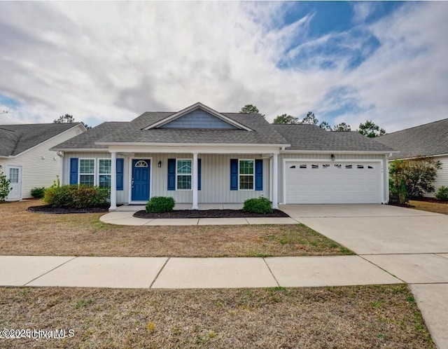 view of front of home featuring roof with shingles, an attached garage, board and batten siding, driveway, and a front lawn