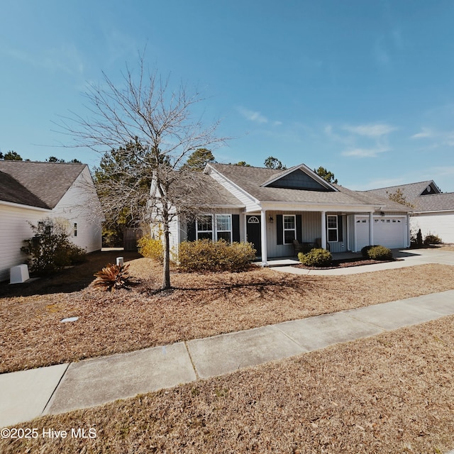 ranch-style home with a garage, driveway, and board and batten siding