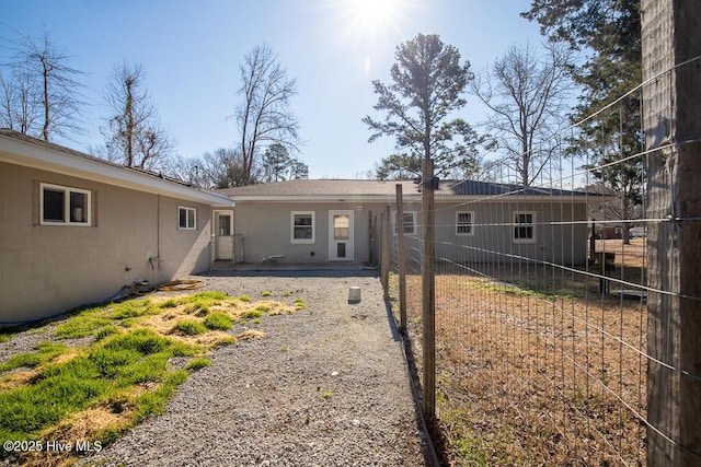 rear view of property featuring fence