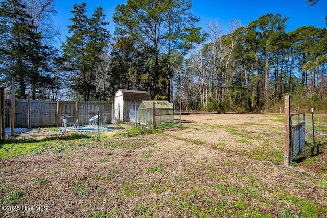 view of yard featuring an outdoor structure and a fenced backyard