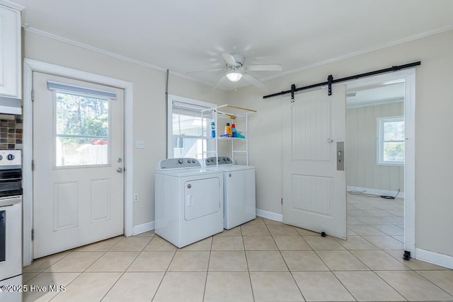 laundry area featuring a barn door, ceiling fan, crown molding, separate washer and dryer, and light tile patterned flooring