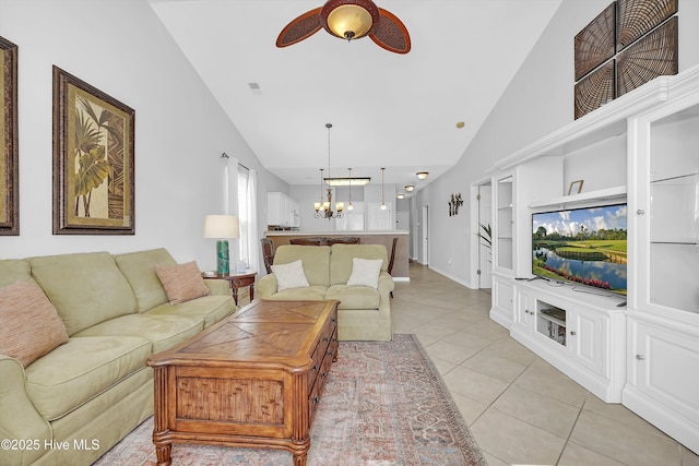 living room featuring visible vents, light tile patterned flooring, high vaulted ceiling, baseboards, and ceiling fan with notable chandelier