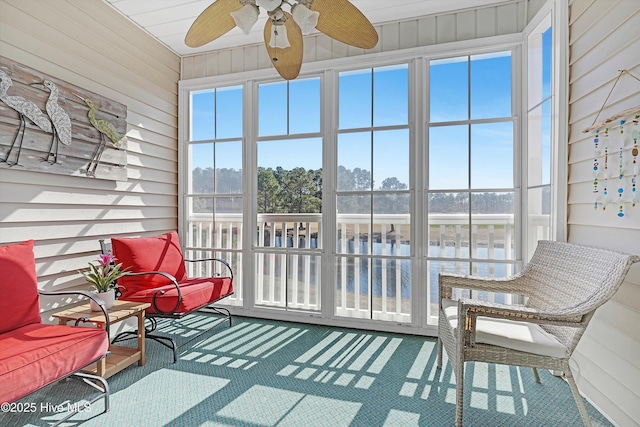 sunroom / solarium with a ceiling fan and a wealth of natural light